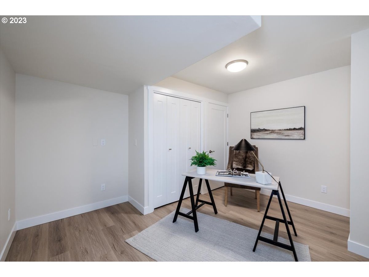 4011 Southwest 43rd Avenue Portland, OR 97221 - Photo 28 of 46 a workspace with furniture and wooden floor