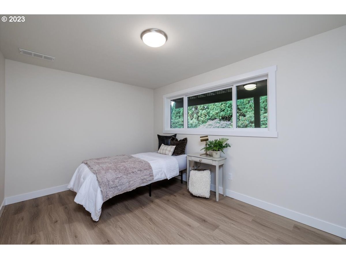 4011 Southwest 43rd Avenue Portland, OR 97221 - Photo 29 of 46 a living room with a bed furniture and a window