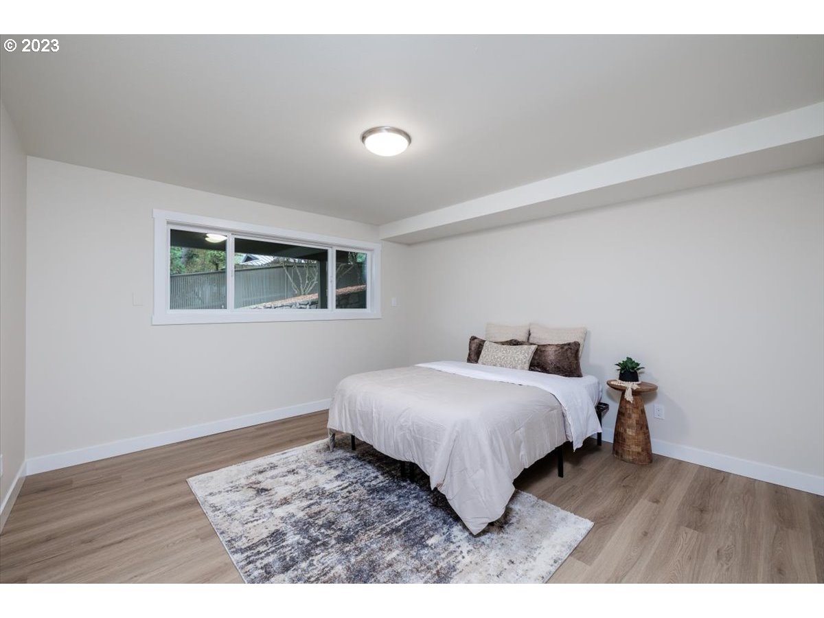 4011 Southwest 43rd Avenue Portland, OR 97221 - Photo 31 of 46 a bedroom with a bed window and wooden floor