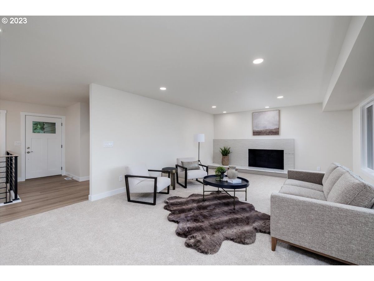 4011 Southwest 43rd Avenue Portland, OR 97221 - Photo 8 of 46 a living room with furniture and a fireplace