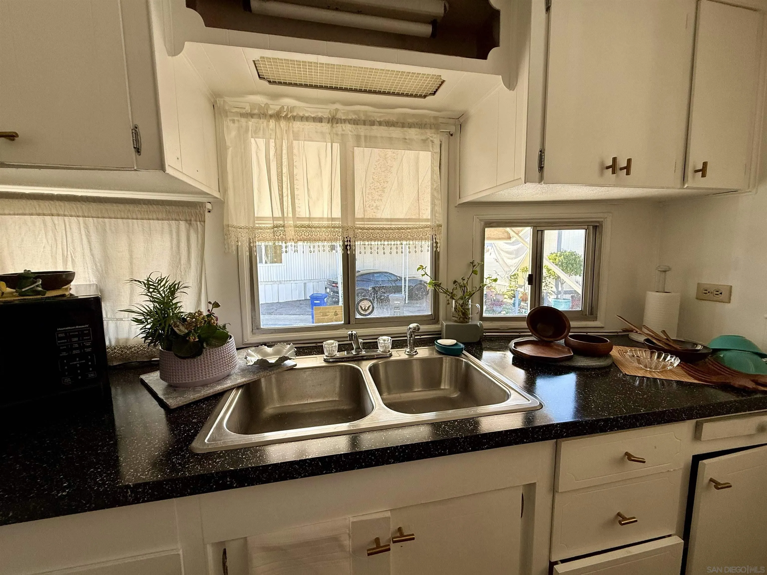 1174 East Main Street El Cajon, CA 92021 - Photo 12 of 23 a kitchen with a sink and cabinets