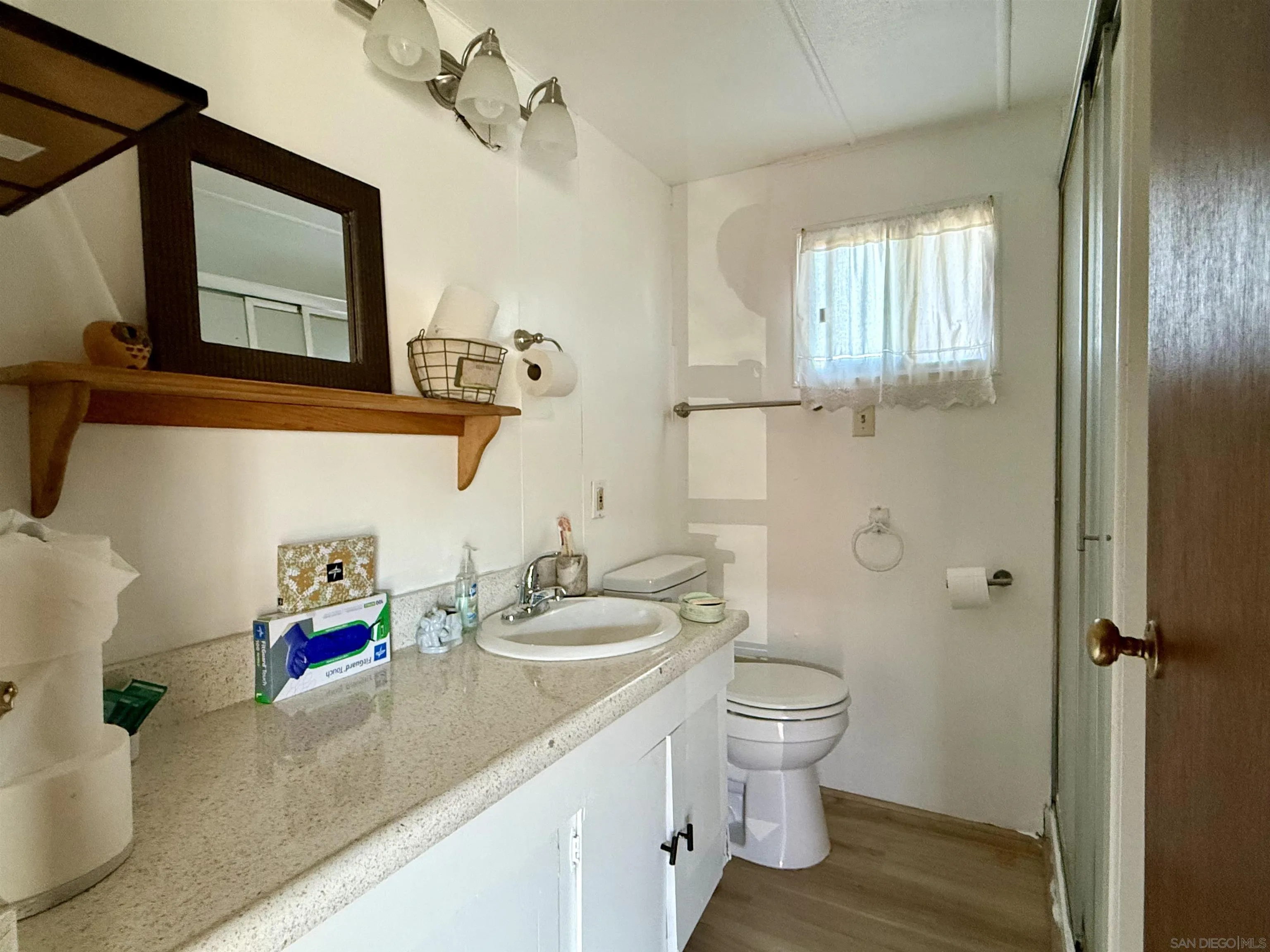 1174 East Main Street El Cajon, CA 92021 - Photo 17 of 23 a bathroom with a granite countertop sink toilet and shower
