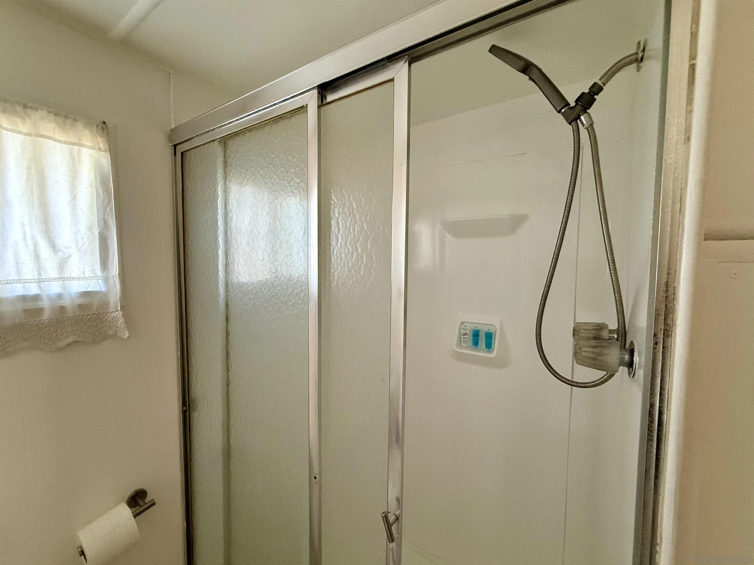 1174 East Main Street El Cajon, CA 92021 - Photo 18 of 23 a bathroom with a glass shower door
