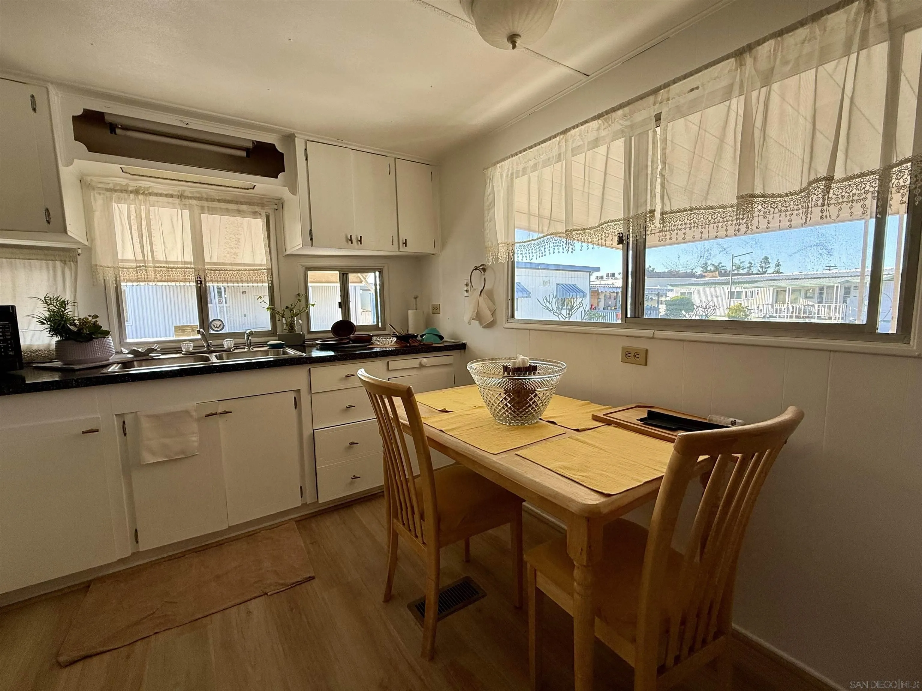 1174 East Main Street El Cajon, CA 92021 - Photo 23 of 23 a kitchen with sink a window and chairs