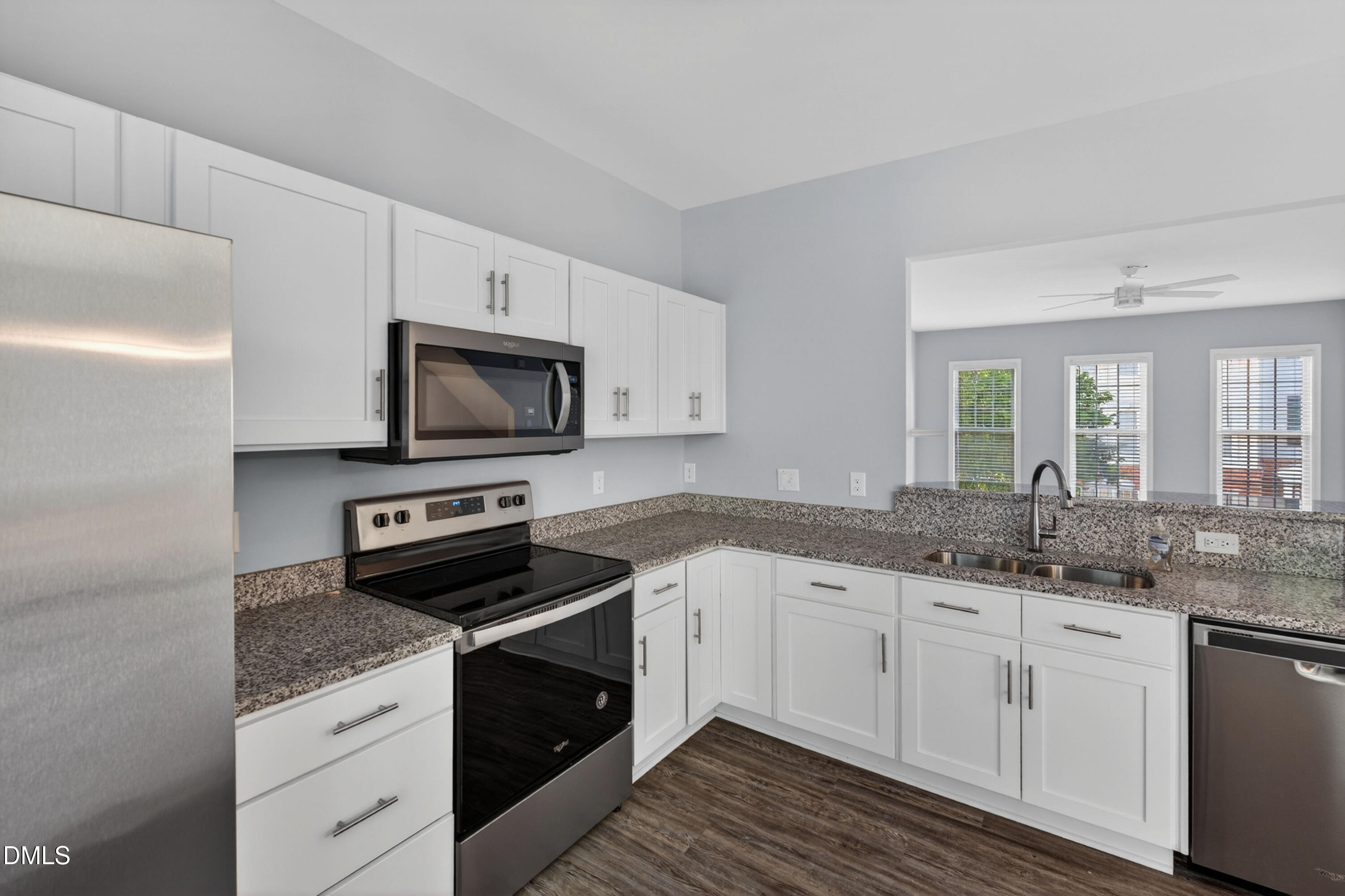 5421 Golden Arrow Lane Raleigh, NC 27613 - Photo 23 of 49 a kitchen with granite countertop white cabinets and stainless steel appliances