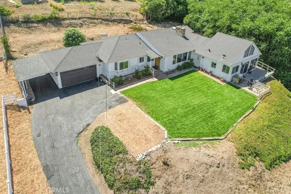 an aerial view of a house with a garden