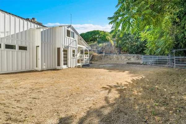a view of a backyard with wooden fence
