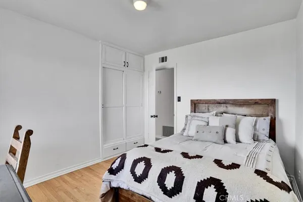 a bedroom with a bed and a painting on the wall