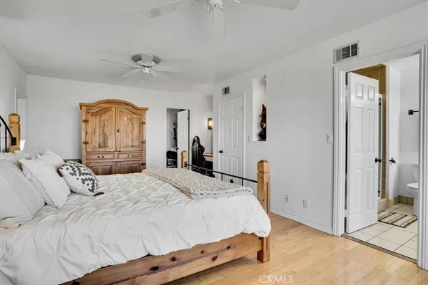 a living room with furniture a flat screen tv and a floor to ceiling window