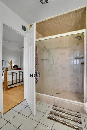 a living room with a couch and a potted plant