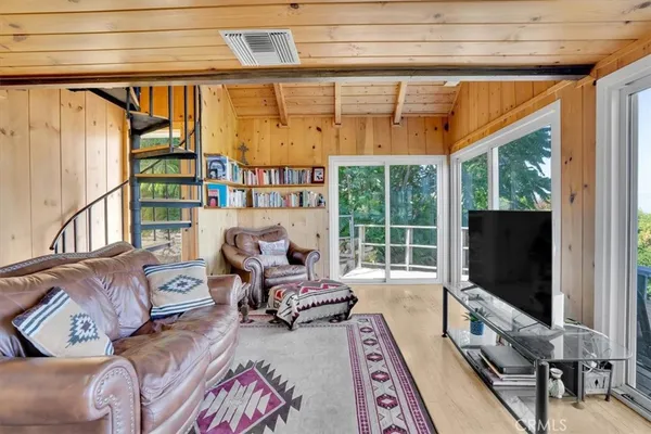 a bedroom with furniture and a large window