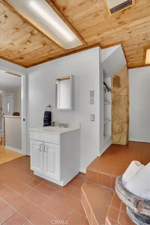 a view of a patio with table and chairs potted plants and large tree