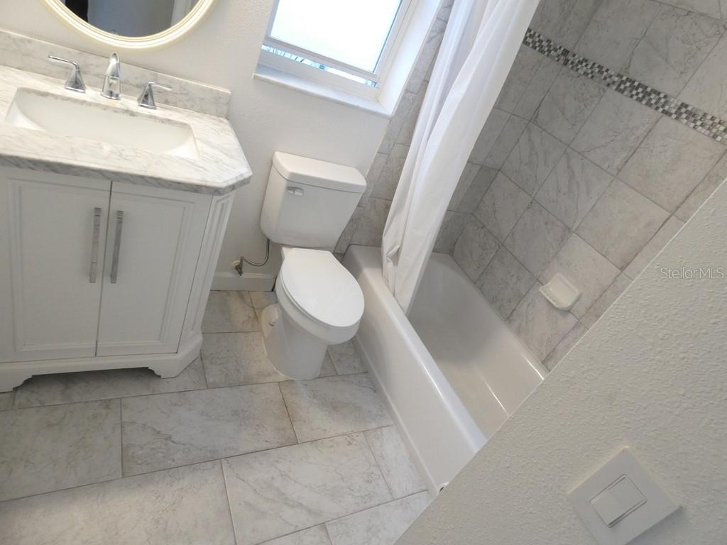 1960 Union Street, Unit 41 Clearwater, FL 33763 - Photo 22 of 45 a bathroom with a sink toilet and vanity