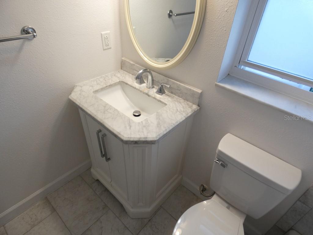1960 Union Street, Unit 41 Clearwater, FL 33763 - Photo 24 of 45 a bathroom with a sink toilet and mirror