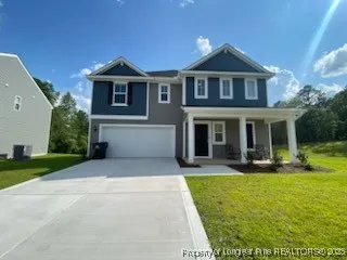 a front view of a house with yard and green space