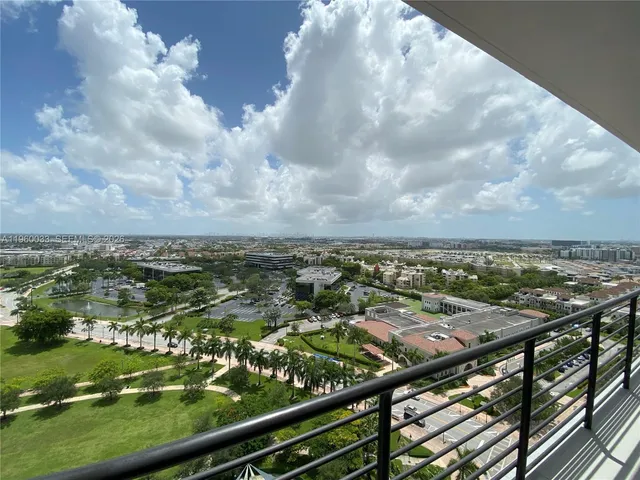 a view of a patio with a table and chairs and potted plants