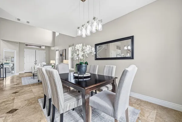 a dining room with furniture and chandelier