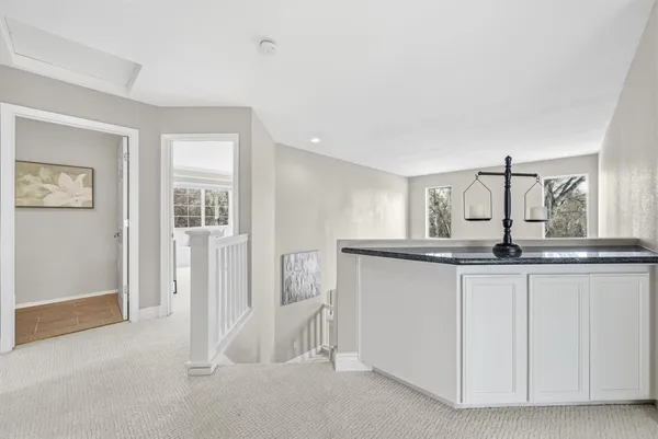 a kitchen with granite countertop white cabinets and sink