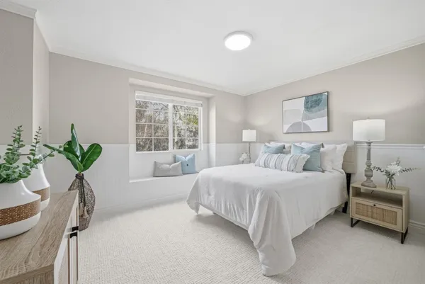 a bedroom with a bed and a lamp