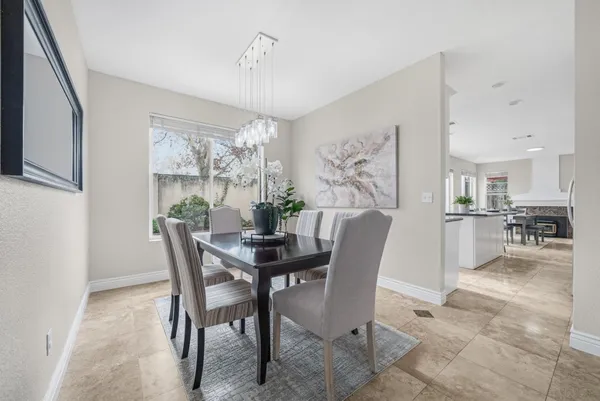 a view of a dining room with furniture and a chandelier