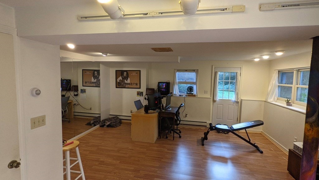 55 West Pelham Road Shutesbury, MA 01072 - Photo 32 of 32 a living room with furniture a wooden floor and a window