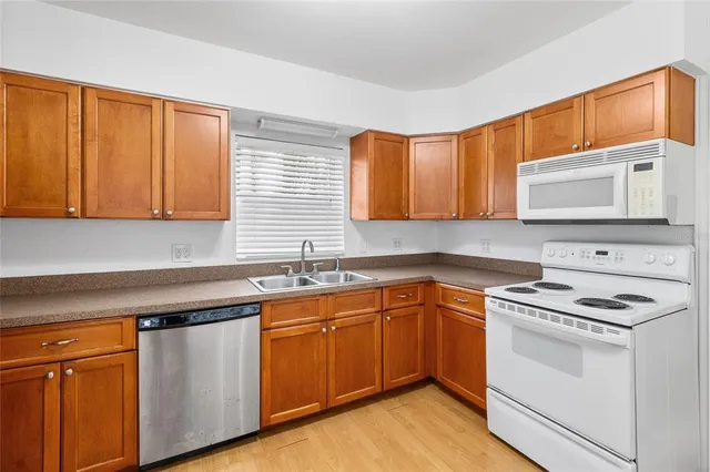 a kitchen with stainless steel appliances granite countertop a sink stove and microwave