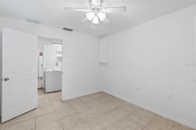 a view of a kitchen with a sink and a refrigerator