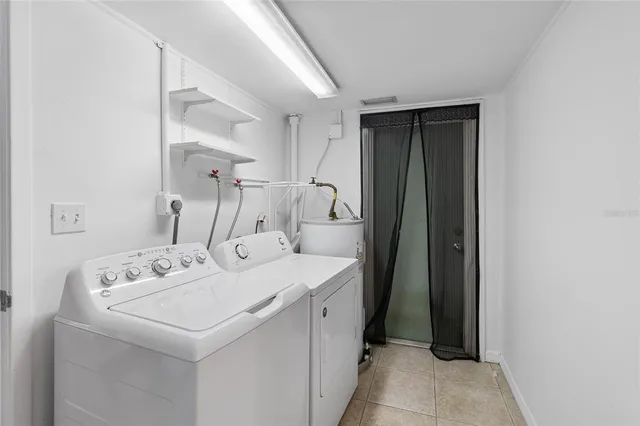 a utility room with sink dryer and washer