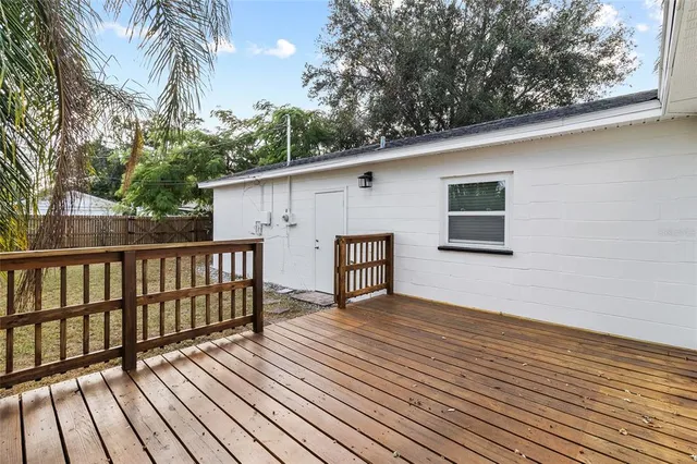 a view of backyard with a deck