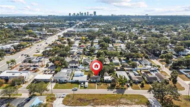 an aerial view of residential houses with outdoor space and swimming pool