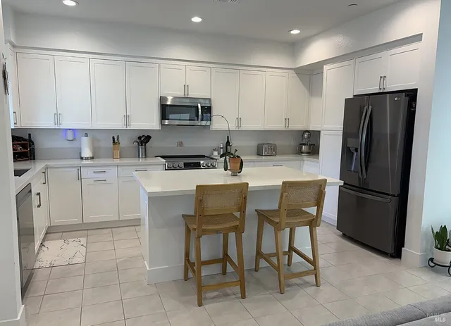 a stove top oven sitting inside of a kitchen