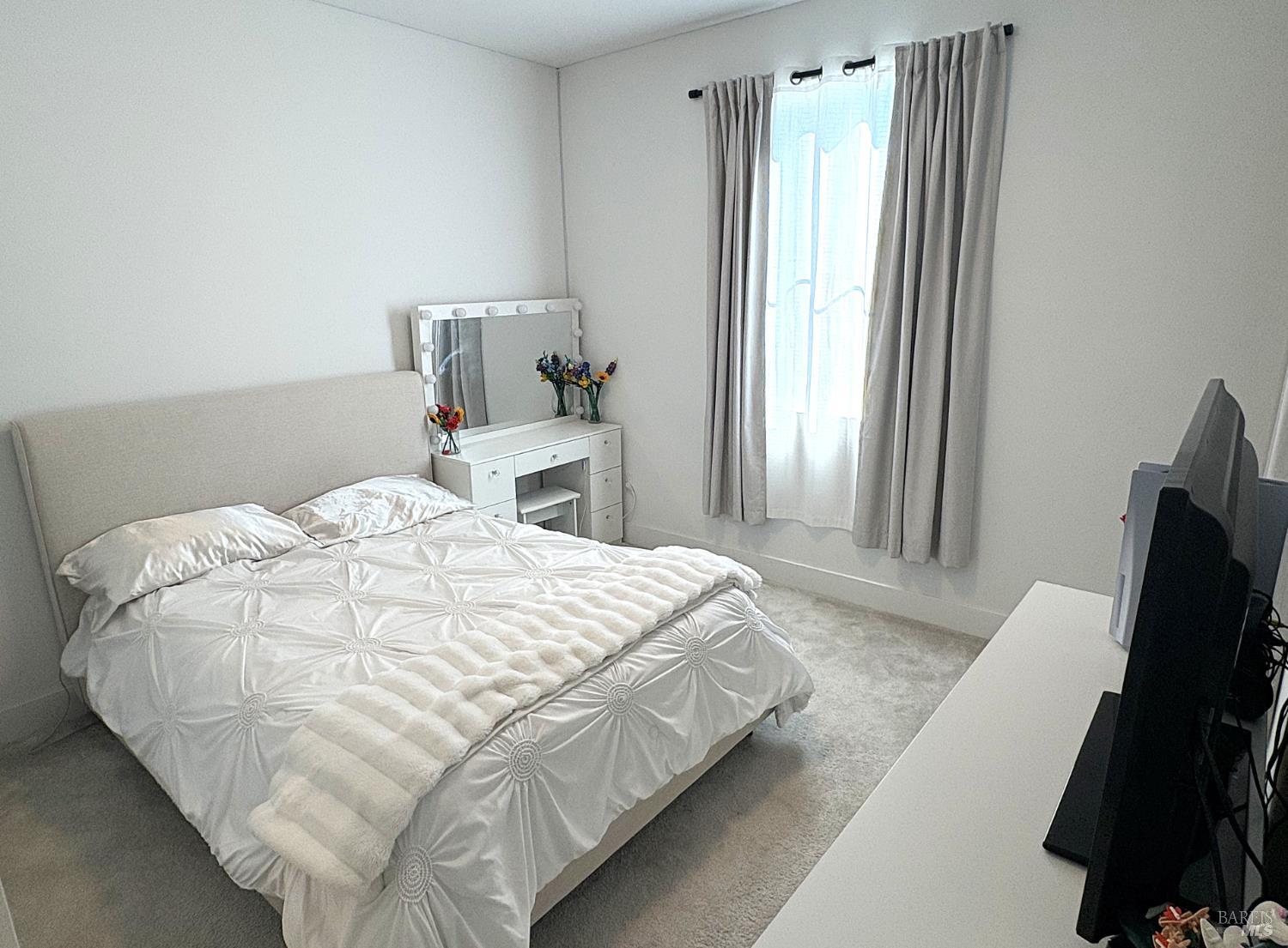 2912 Liscum Street Santa Rosa, CA 95407 - Photo 19 of 25 a bedroom with a bed and a flat tv screen on a dresser