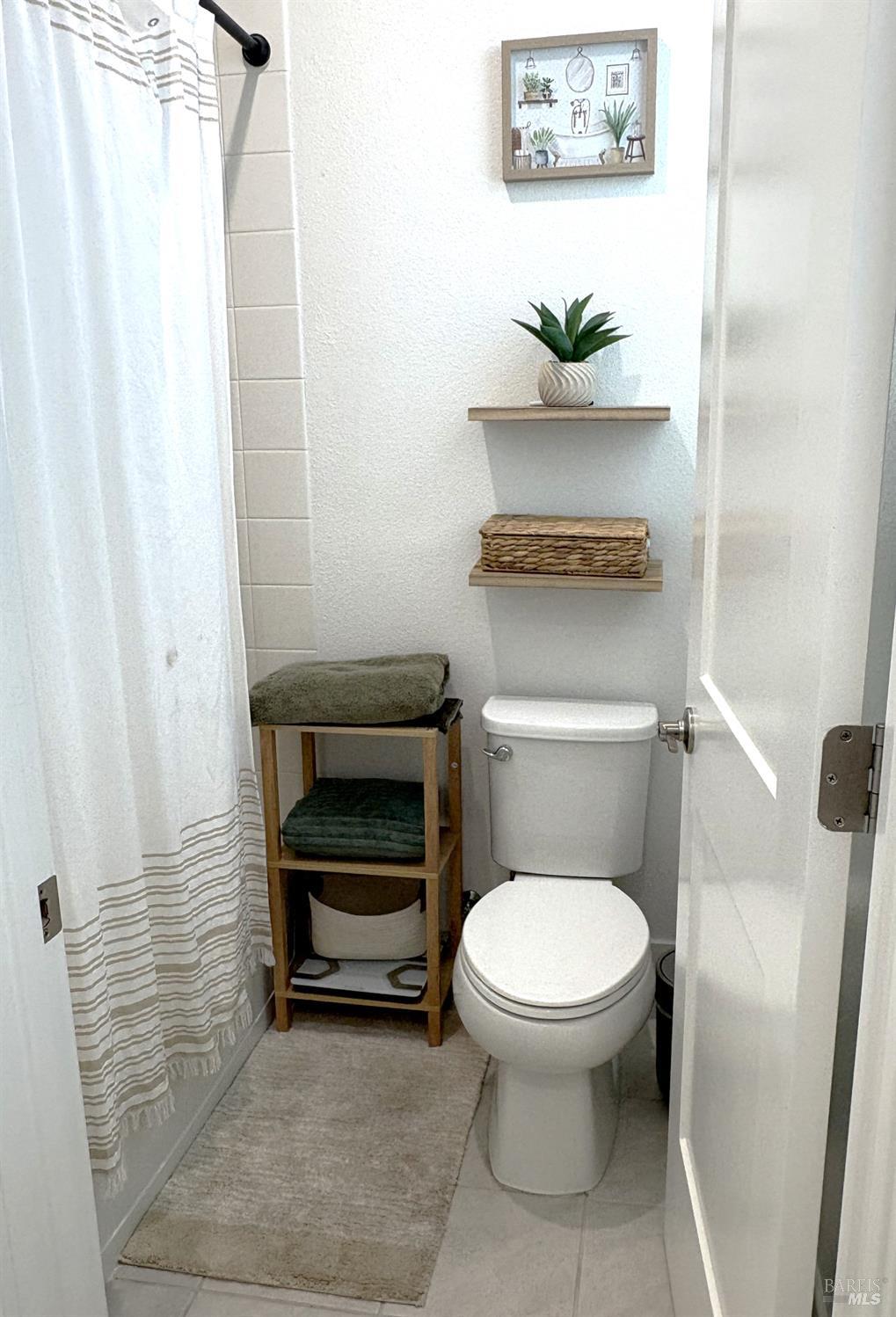 2912 Liscum Street Santa Rosa, CA 95407 - Photo 21 of 25 a bathroom with a toilet and a mirror