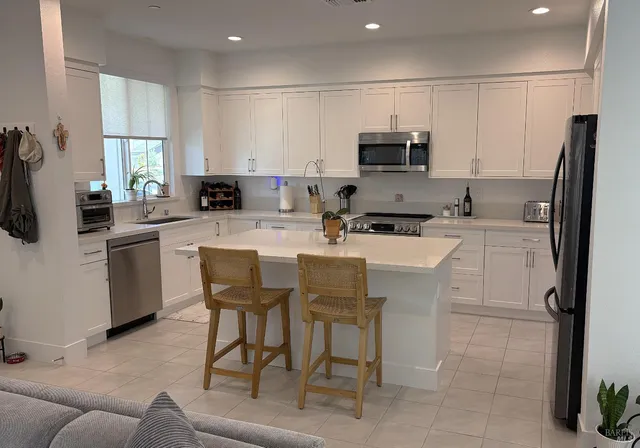 a kitchen with a sink stainless steel appliances and cabinets