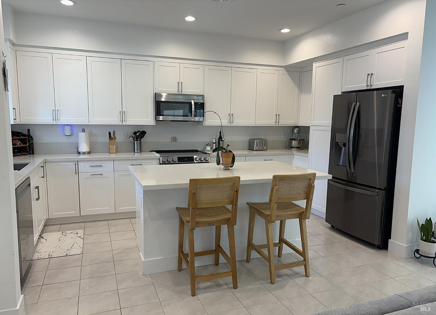 2912 Liscum Street Santa Rosa, CA 95407 - Photo 4 of 25 a kitchen with stainless steel appliances a refrigerator sink microwave and cabinets