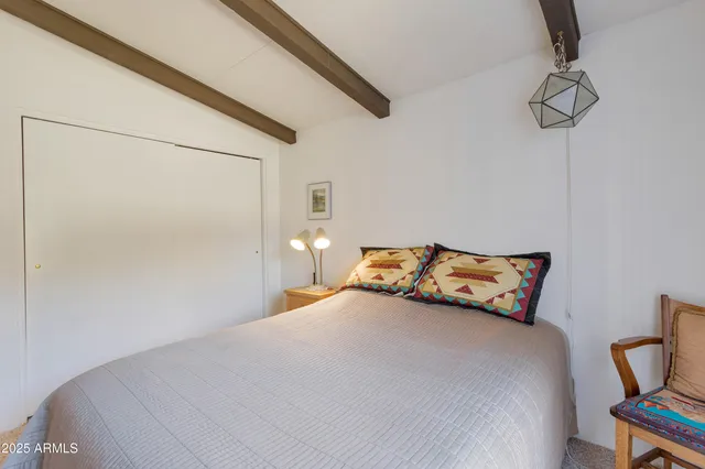 a bedroom with a bed and a chair