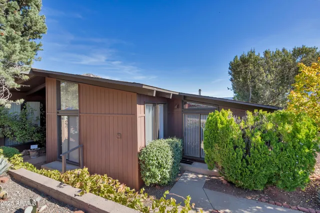 a couple of potted plants in front of door