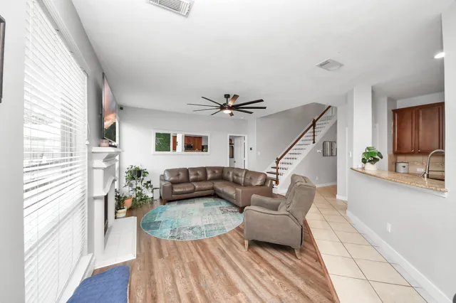 a living room with furniture and a wooden floor