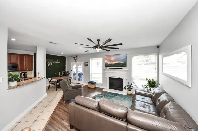 a living room with furniture fireplace and a large window