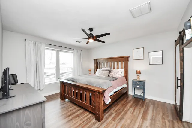 a bedroom with a bed and a table in it