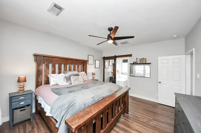 a bedroom with a bed and a chandelier