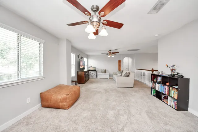 a living room with hard wood floor furniture and a window