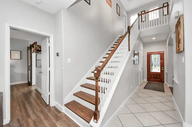 a view of staircase with lots of frames and wooden floor