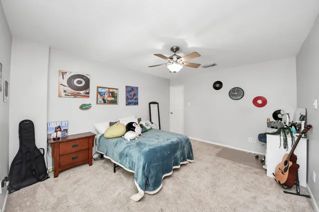 a bedroom with furniture and a flat screen tv