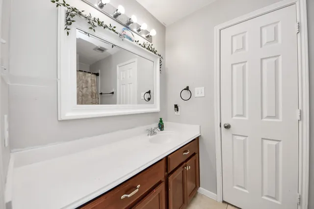 a bathroom with a sink vanity and a mirror
