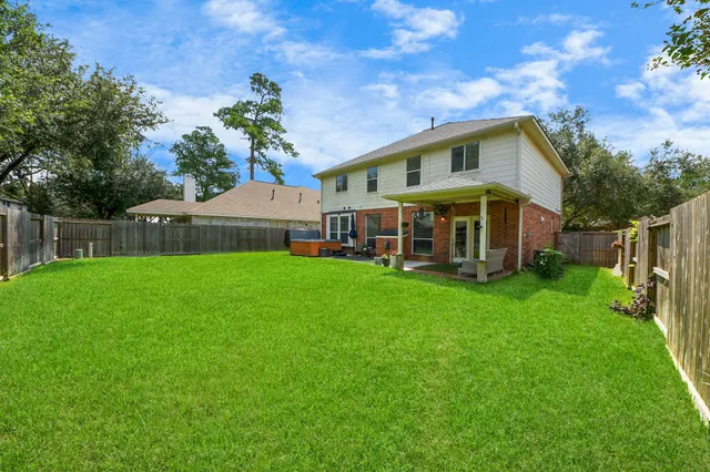 a view of an house with backyard space and balcony