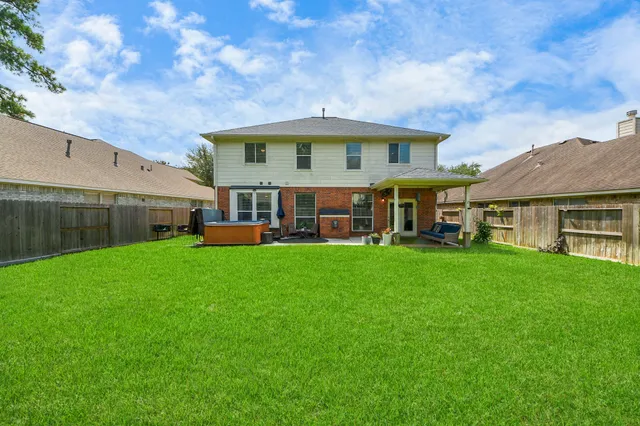 a view of house with yard and entertaining space