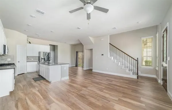 a view of a kitchen with a sink stainless steel appliances and cabinets