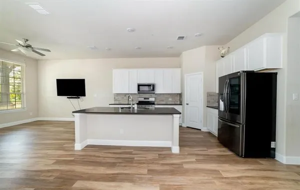a kitchen with stainless steel appliances a refrigerator stove and microwave
