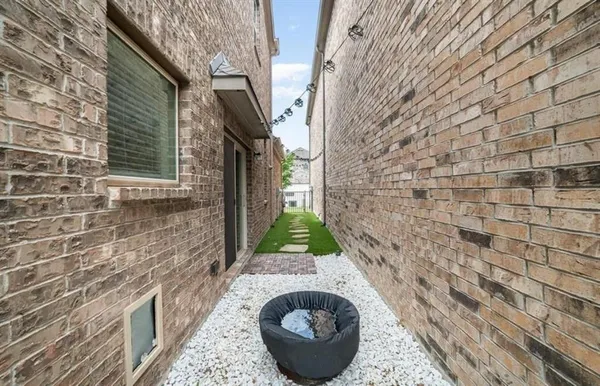 a brick house with a sink and a yard